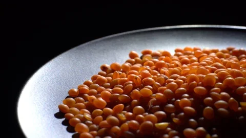 Lentils. Heap of raw uncooked red lentils in bowl in rotation. Stock Footage 102479031