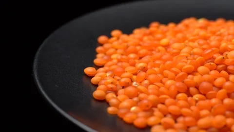 Lentils. Heap of raw uncooked red lentils in bowl in rotation. Stock Footage 102479131