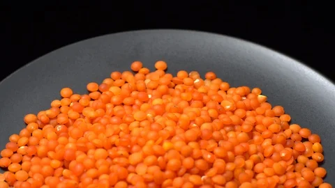 Lentils. Heap of raw uncooked red lentils in bowl in rotation. Stock Footage 102479163