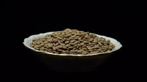 Lentils. Rotation. Close up. Heap of raw uncooked brown lentils. Stock Footage 102411406