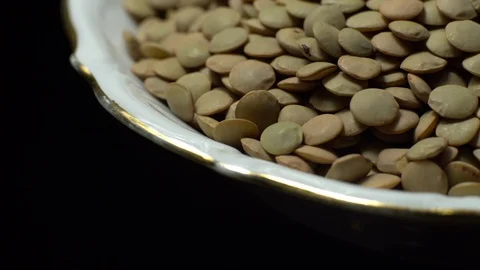 Lentils. Rotation. Close up. Heap of raw uncooked brown lentils. Video stock 102411530