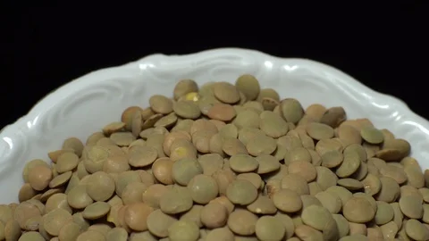 Lentils. Rotation. Close up. Heap of raw uncooked brown lentils. Video stock 102411580