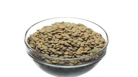 Lentils. Rotation. Close up. Heap of raw uncooked brown lentils. Video stock 102412659