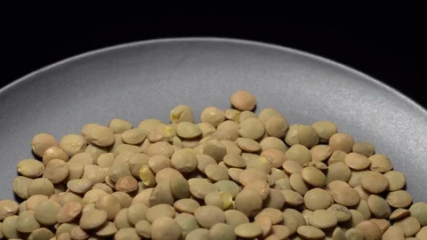 Lentils. Rotation. Close up. Heap of raw uncooked brown lentils. Video stock 102442134