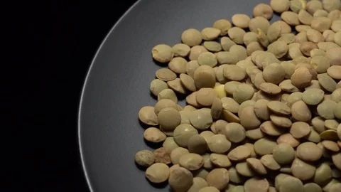 Lentils. Rotation. Close up. Heap of raw uncooked brown lentils. Video stock 102442432