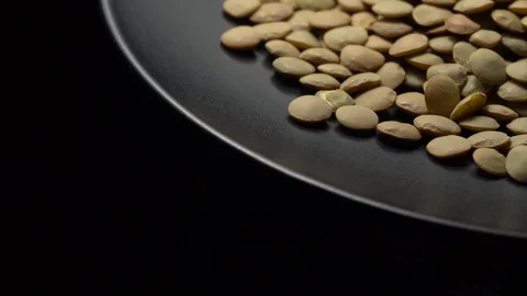 Lentils. Rotation. Close up. Heap of raw uncooked brown lentils. Video stock 102458518