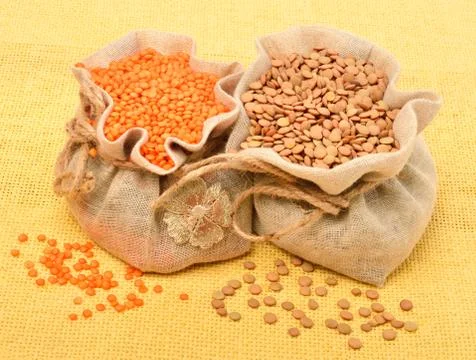 Lentils in the sack on the tablecloth Stock Photos