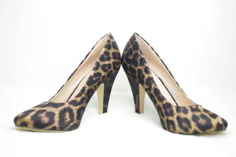 Leopard-colored shoes on a white background. Selective focus. Stock Photos