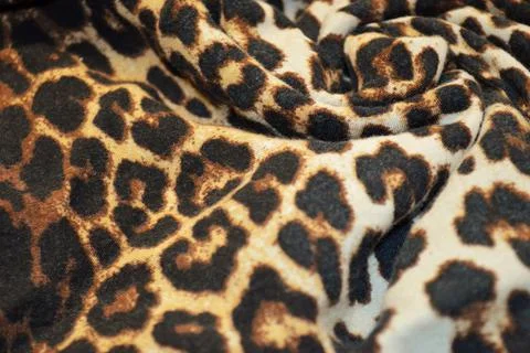 Leopard print textile as a background. Leopard print material texture on fabr Stock Photos