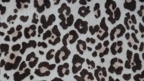 Leopard print textile pattern close up on fabric surface with brown spots o.. Stock Photos