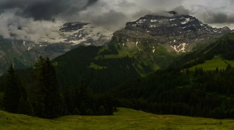 Les Diablerets peak being covered in clouds Swiss alpine meadow Stock Footage 52219574