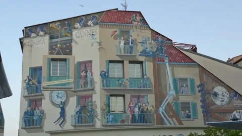 Les Murs Peints – Cinéma Cannes mural on facade with film set balconies Stock Footage 320747347