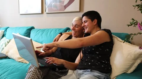 Lesbian Couple Enjoying Internet Browsing on Laptop Stock Footage 274674900