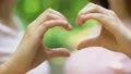 Lesbian couple making heart with hands, kissing each other with all love, lgbt HD Footage