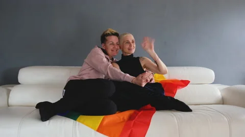 Lesbian Couple Sitting On The Couch Stock Footage 153670227