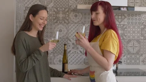 Lesbian Couple Smiling While Cooking at Home 库存影片 334318187