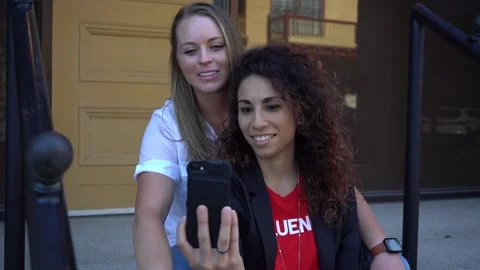 Lesbian couple takes a selfie while seated Stock Footage 132148716
