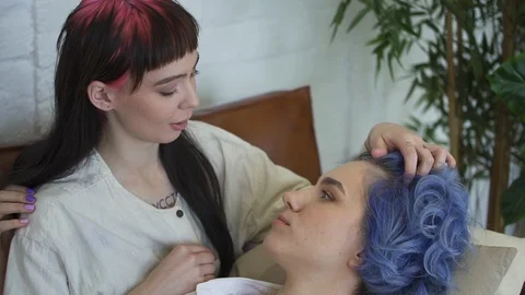 Lesbian couple talking together while lying on sofa at home. concept discussing Stock Footage 126715430