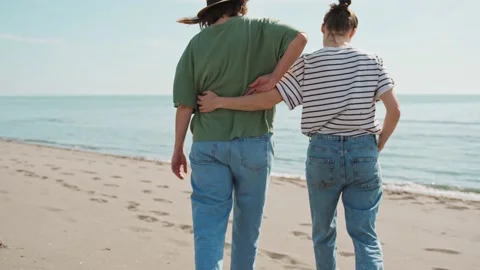 A lesbian couple walking the beach Stock Footage 238898868