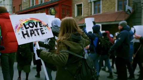 Lesbian crowd protesting sity street. Lgbt pride demonstration banners. Lgbtq. Stock Footage 303494129