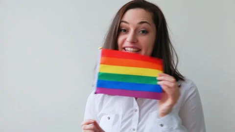 Lesbian girl with LGBT rainbow flag isol... | Stock Video | Pond5