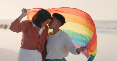 Lesbian couple. Two young women in a bright bedroom.