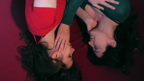 Lesbians lying on the bed tenderly look into each other's eyes Stock Footage 167240435