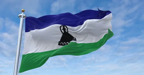 Lesotho flag with flagpole waving in rolling clouds looping, 4K Perfect Loop Stock Footage 280033609