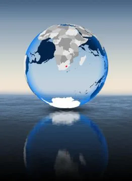 Lesotho on globe in water Illustrazione stock