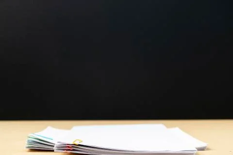 Less of Stack of document paper with colorful paperclip place on wooden table Stock Photos