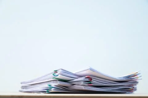 Less of Stack of document paper with colorful paperclip place on wooden table Stock Photos
