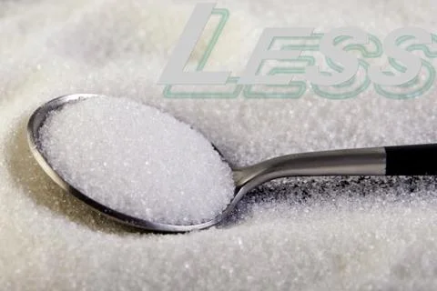 Less text, sugar slide on a spoon, suggesting a diet and health concept Stock Photos