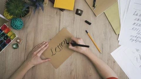 Lesson 7 Writing In A Craft Paper in Hand Lettering Way Stock Footage 148695033