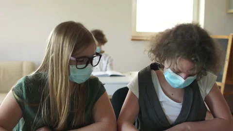 Lesson in the classroom in high school. Masked children in the classroom, write Stock Footage 167470652