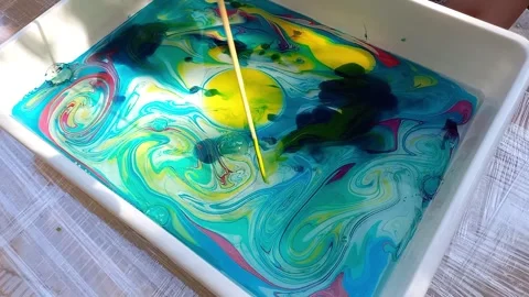 Lesson on drawing technique Ebru. child drawing, creating pattern on water. Stock Footage 256146714