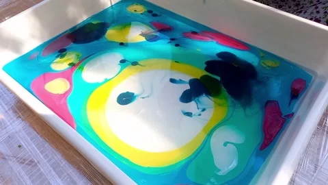 Lesson on drawing technique Ebru. child drawing, creating pattern on water. Stock Footage 256147226