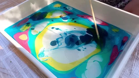 Lesson on drawing technique Ebru. child drawing, creating pattern on water. Stock Footage 256147239