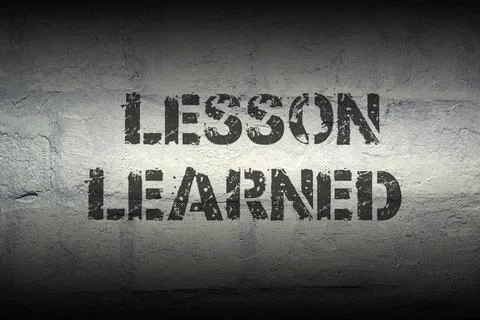 Lesson learned gr lesson learned stencil print on the grunge white brick w... Stock Photos
