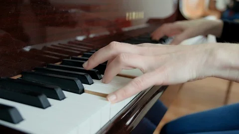 A lesson in a music school, learning to play the piano. Female hands play the Stock Footage 119885958