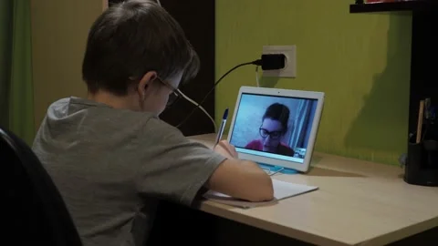Lesson online. the boy writes down a task in a notebook Stock Footage 147937758