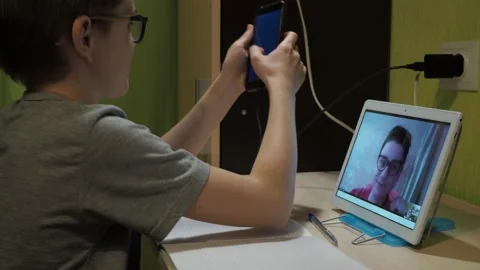 Lesson online. a young teacher explains the program. the boy picks up the phone Stock Footage 147447336