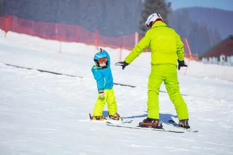 Lesson at skiing school: instructor teaching little skier how to make turns Stock Photos