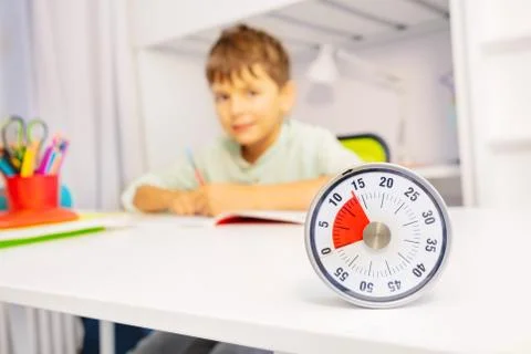 Lesson timer and boy doing exercises on background Stock Photos