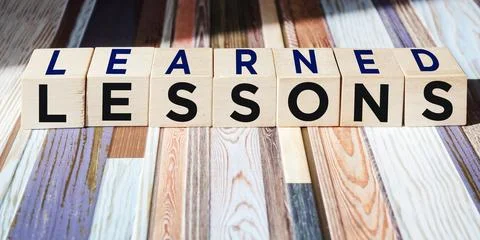 Lessons learned text on wooden blocks on a beautiful background. Business edu Stock Photos