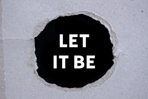 Let it be message written on ripped torn paper on black background. Concept.. Foto stock