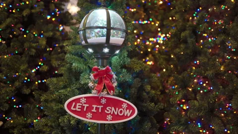 Let it snow written words on oval red board hanging on black lamp, xmas mood Stock-Footage 140202271
