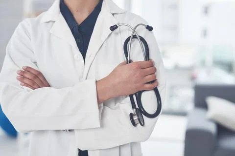 Let me diagnose you. an unrecognizable female doctor holding a stethoscope while Stock Photos