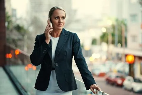Let me think it over...an attractive mature businesswoman using her cellphone Stock Photos