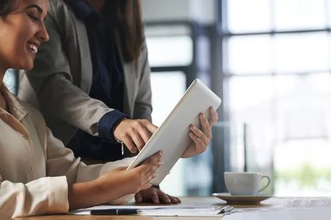Let technology help simplify your workload. two colleagues working together on a Stock Photos