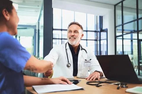 Lets collaborate and continue to save lives. doctors shaking hands during a Stock Photos